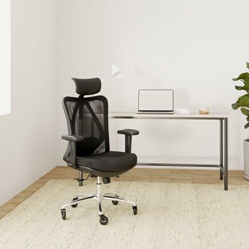 Office chair and desk with laptop in a minimalist room.