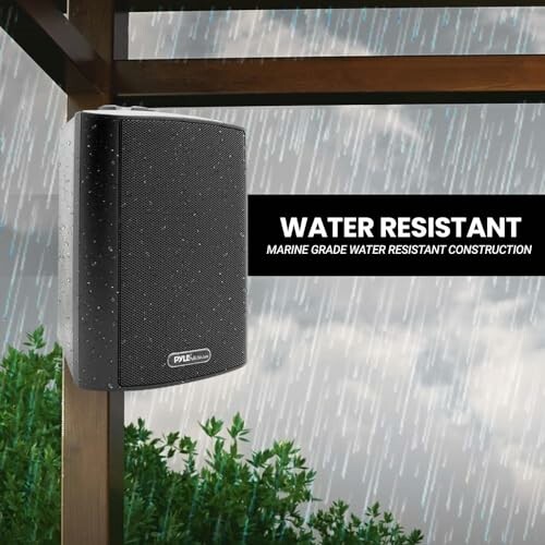 Outdoor water-resistant speaker mounted under a pergola in the rain.