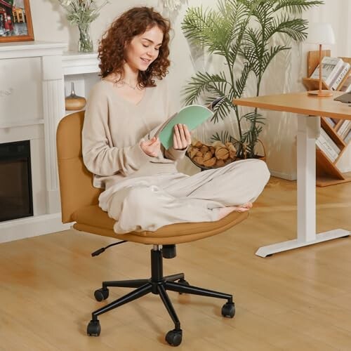 Woman sitting cross-legged on an office chair in a cozy room